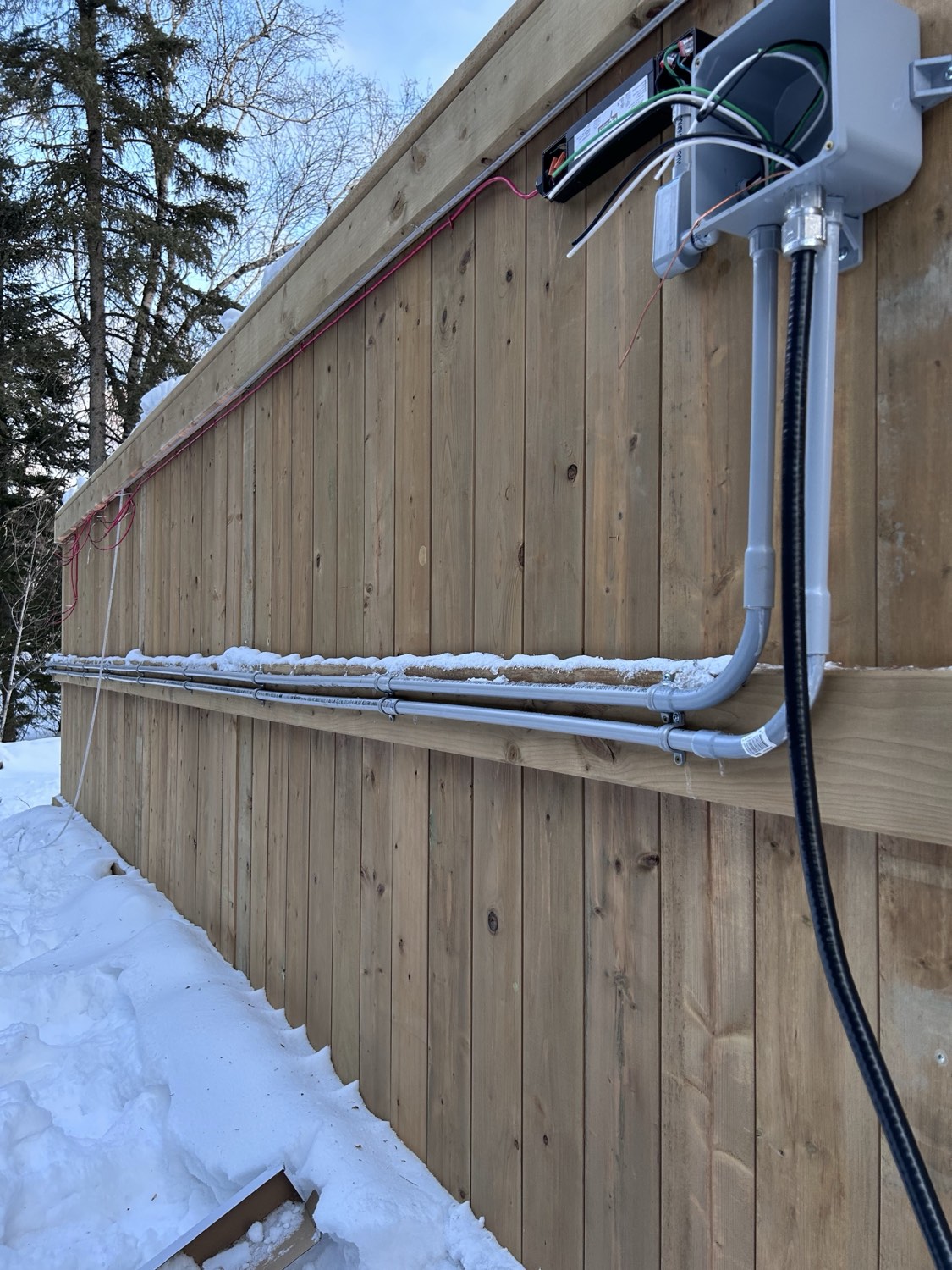 Exterior conduit run installed in winter snow conditions