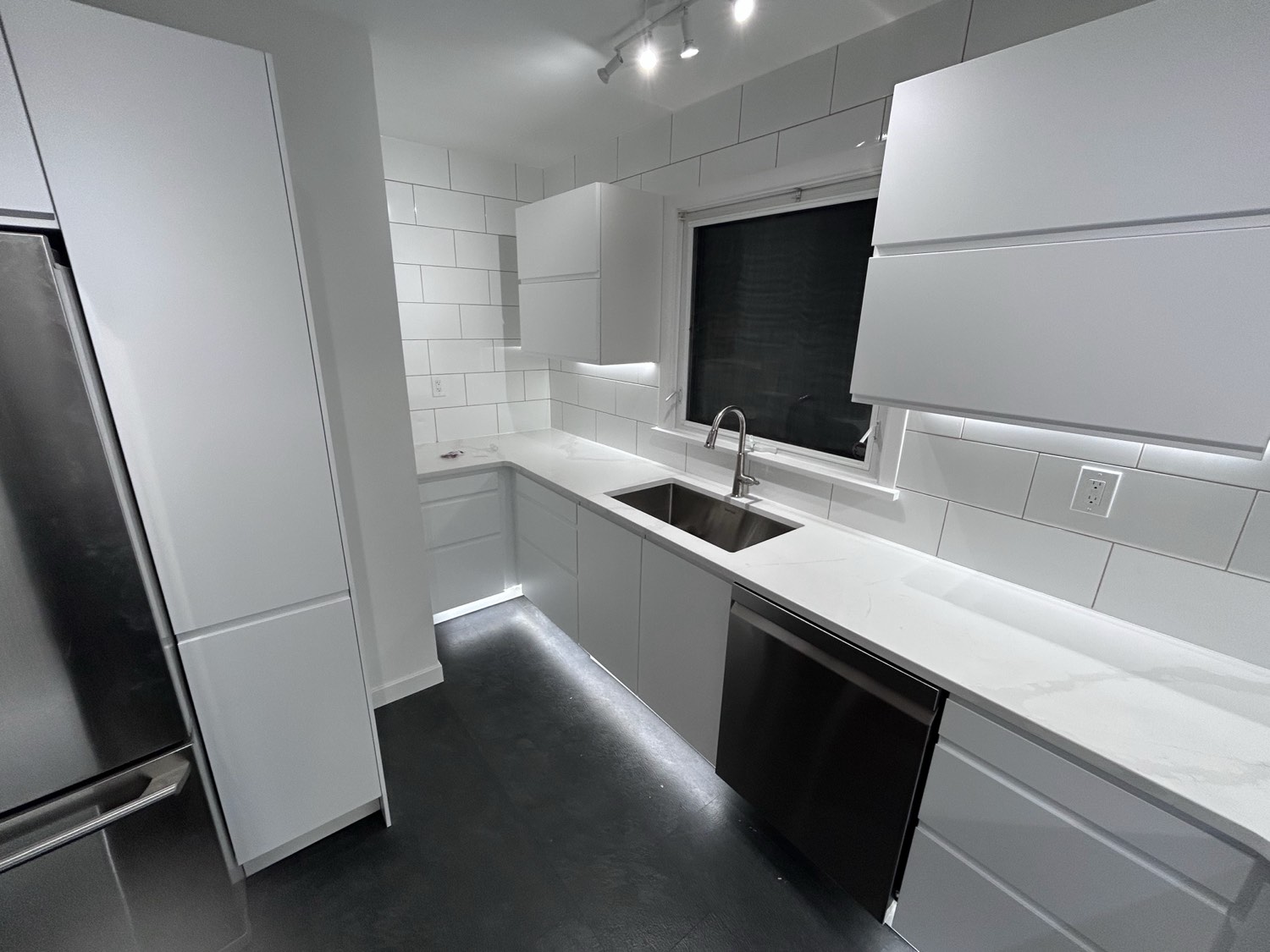 White kitchen with under-cabinet and toe-kick LED lighting