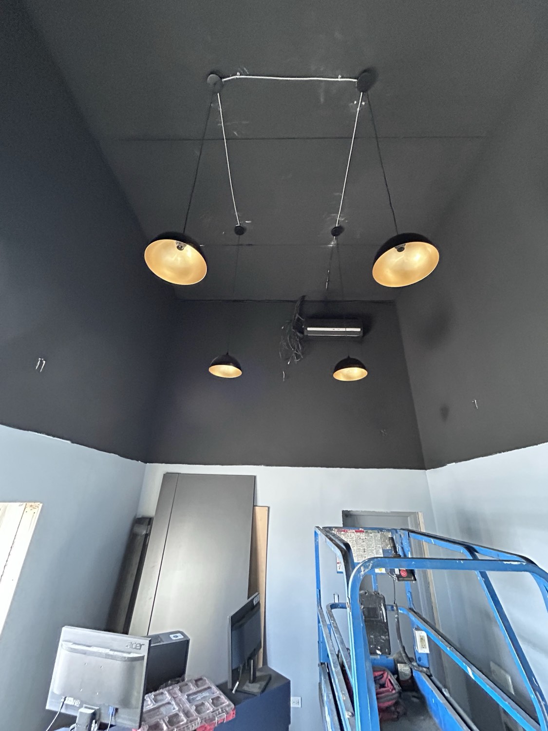 Gold dome pendant lights on a dark feature ceiling